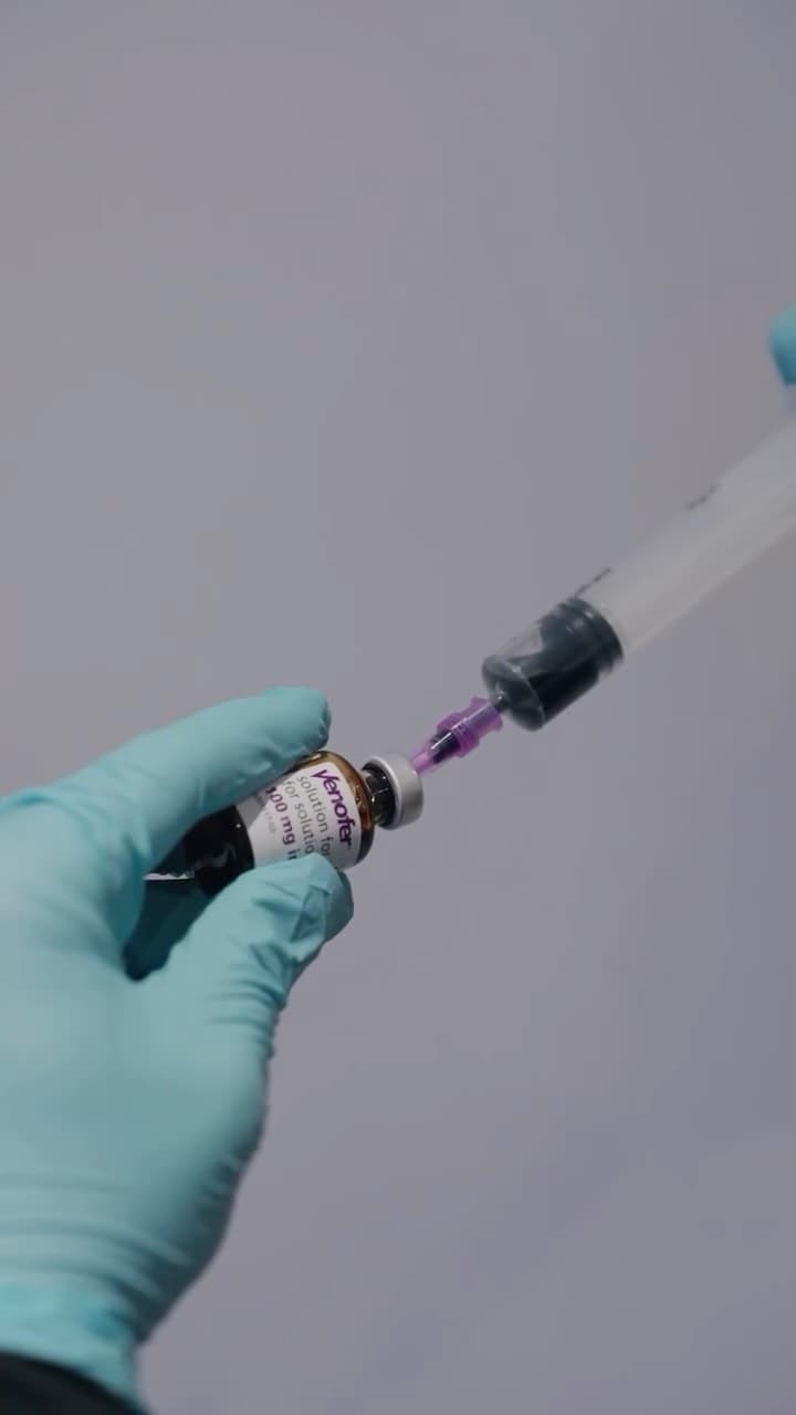 Drawing iron solution from a vial into a syringe at Drip IV
