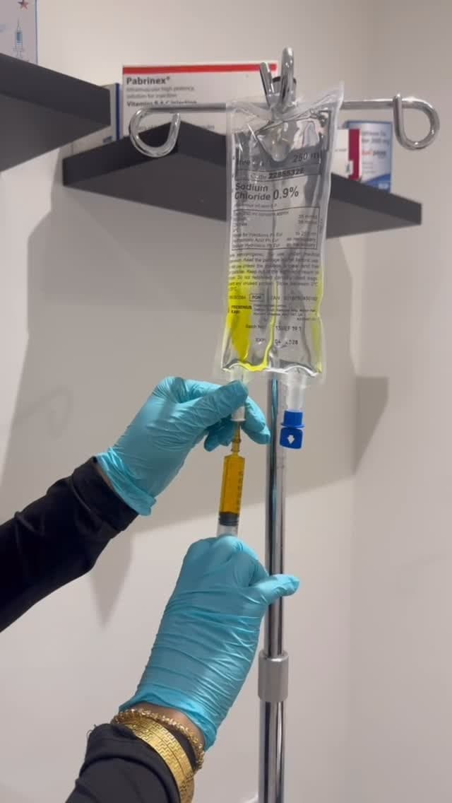 Preparing a saline IV bag and syringe at Drip IV